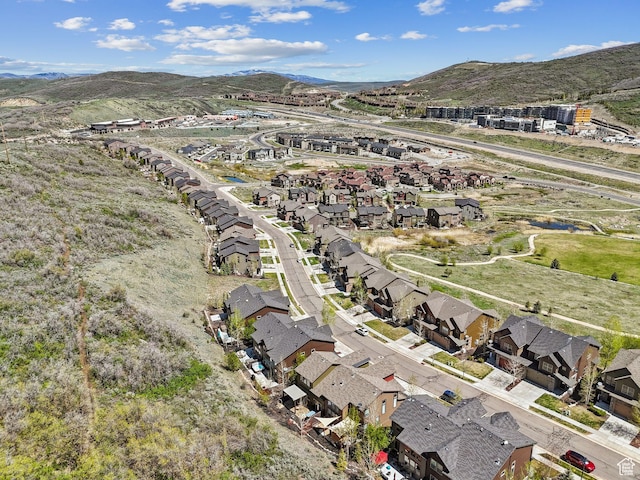 aerial view of property and surrounding area with nearby suburban area and a mountain backdrop