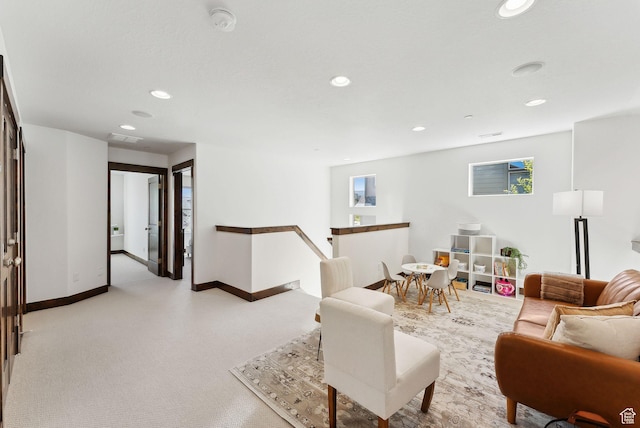 living area featuring recessed lighting and baseboards