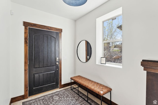 foyer entrance featuring baseboards