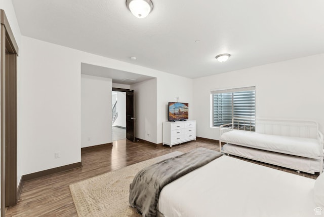bedroom featuring wood finished floors and baseboards