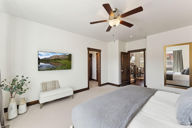 carpeted bedroom featuring baseboards and ceiling fan