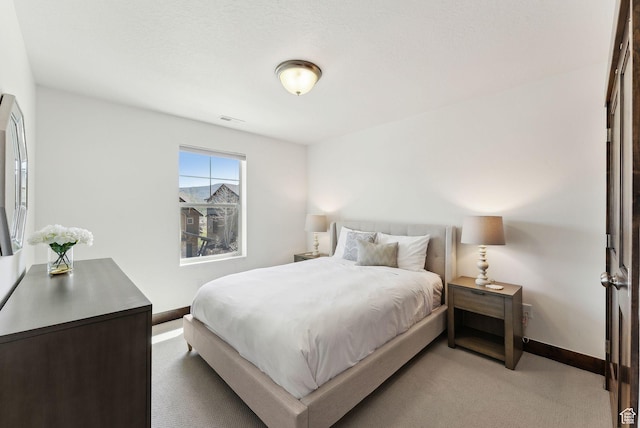 carpeted bedroom featuring baseboards