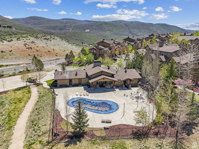 aerial view of property and surrounding area featuring mountains