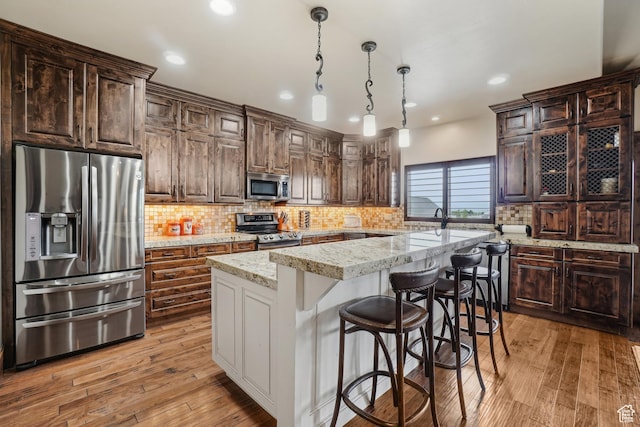 1236 S 2240 E, Heber City, UT 84032 - kitchen with stainless steel appliances, a center island, light wood-type flooring, tasteful backsplash, and recessed lighting