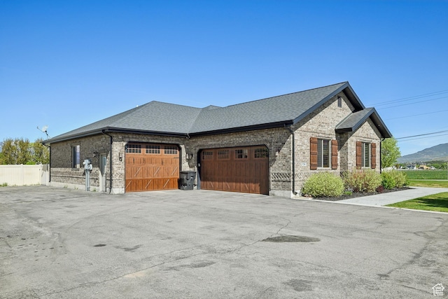 1236 S 2240 E, Heber City, UT 84032 - view of property exterior featuring brick siding, an attached garage, a shingled roof, asphalt driveway, and fence