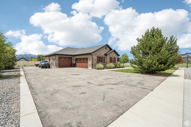 1236 S 2240 E, Heber City, UT 84032 - view of front of property featuring an attached garage, driveway, brick siding, and fence