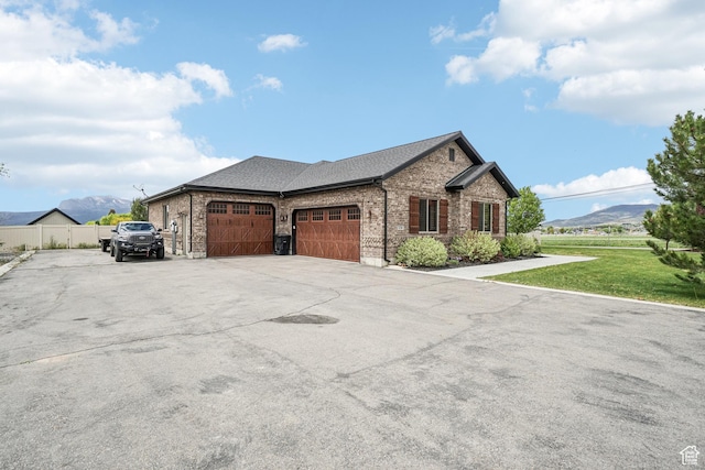 1236 S 2240 E, Heber City, UT 84032 - view of front of home with brick siding, a garage, concrete driveway, a mountain view, and roof with shingles