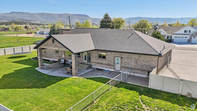 1236 S 2240 E, Heber City, UT 84032 - back of house featuring roof with shingles, brick siding, a patio, a mountain view, and entry steps