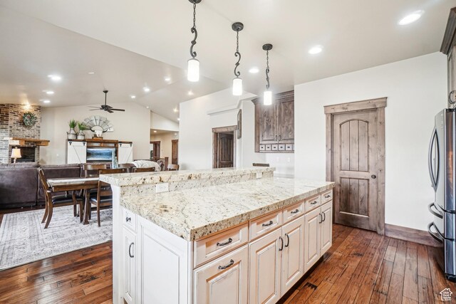 1236 S 2240 E, Heber City, UT 84032 - kitchen featuring ceiling fan, dark wood-style flooring, freestanding refrigerator, light stone counters, and a center island