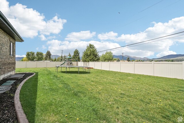 1236 S 2240 E, Heber City, UT 84032 - view of yard featuring a trampoline, a mountain view, and a playground