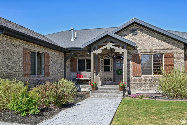 1236 S 2240 E, Heber City, UT 84032 - property entrance featuring brick siding, a porch, roof with shingles, and a yard