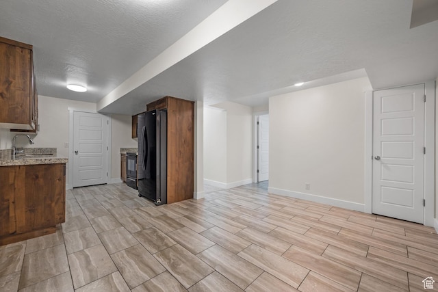 6594 S 1300 W, Taylorsville, UT 84123 - kitchen with black appliances, a sink, baseboards, light stone countertops, and a textured ceiling
