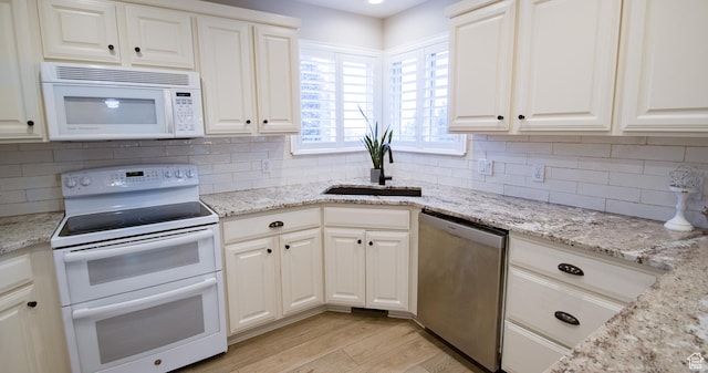 3139 N 800 E, North Ogden, UT 84414 - kitchen with white appliances, a sink, light wood finished floors, white cabinets, and backsplash