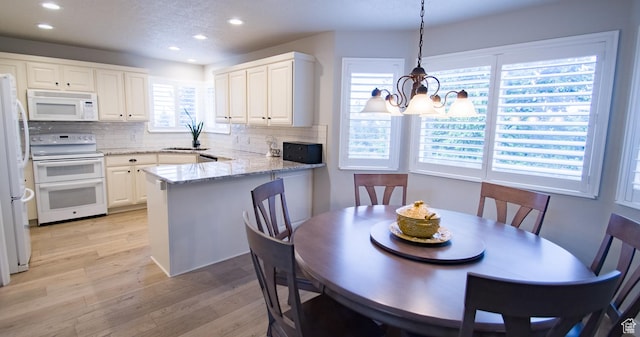 3139 N 800 E, North Ogden, UT 84414 - dining area with recessed lighting, light wood-style flooring, and a chandelier