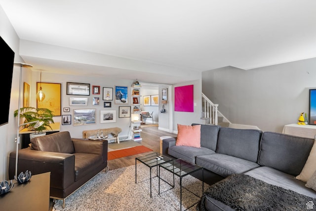 living room with wood finished floors and stairway