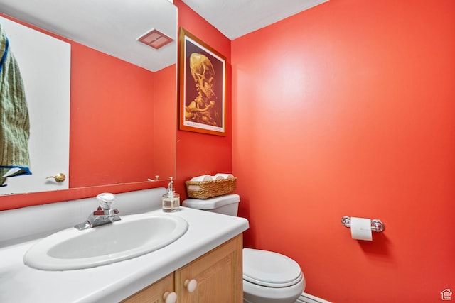 bathroom with toilet and vanity