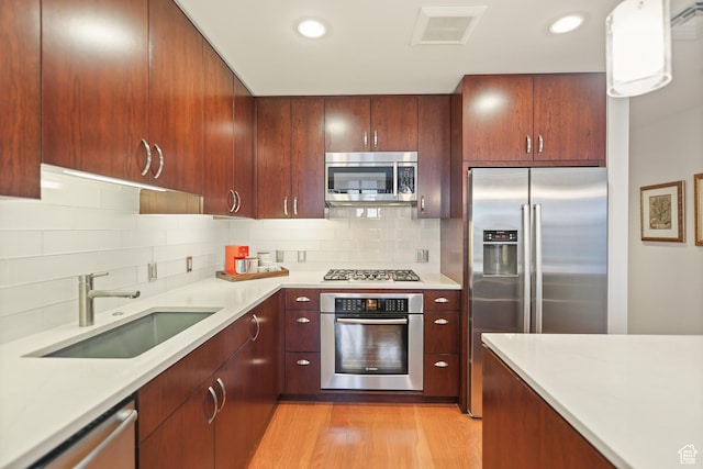 35 E 100 S Unit 507, Salt Lake City, UT 84111 - kitchen featuring appliances with stainless steel finishes, a sink, light countertops, tasteful backsplash, and recessed lighting
