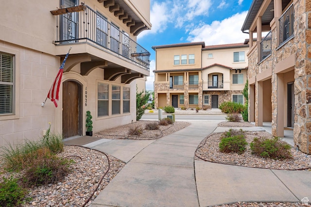 10926 N Marsala Dr, Highland, UT 84003 - view of exterior entry with a balcony and stucco siding