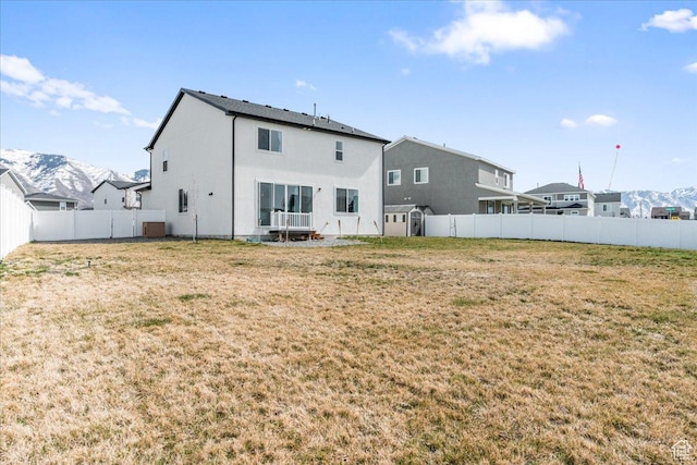 6405 N Appaloosa Dr, Stansbury Park, UT 84074 - rear view of house with a mountain view and stucco siding