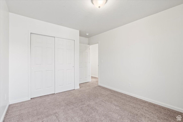 6405 N Appaloosa Dr, Stansbury Park, UT 84074 - unfurnished bedroom featuring carpet, baseboards, and a closet