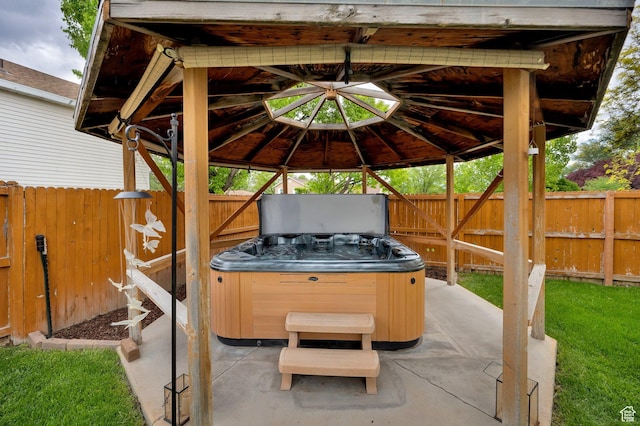 2298 W Jordan Meadows Cv, West Jordan, UT 84084 - view of patio featuring a hot tub, a gazebo, and fence