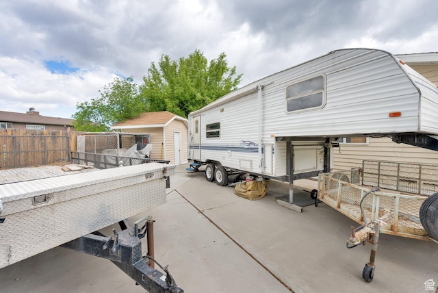 2298 W Jordan Meadows Cv, West Jordan, UT 84084 - back of house with fence, a shed, a patio area, and an outdoor structure