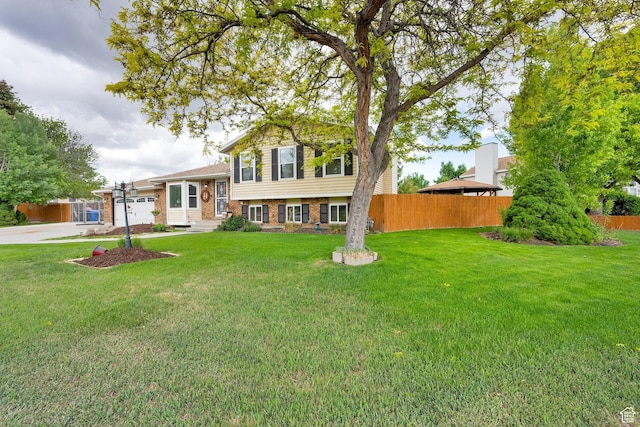 2298 W Jordan Meadows Cv, West Jordan, UT 84084 - split level home with brick siding, driveway, and an attached garage