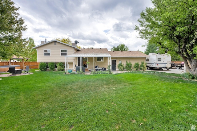 2298 W Jordan Meadows Cv, West Jordan, UT 84084 - back of house with a hot tub and a patio area