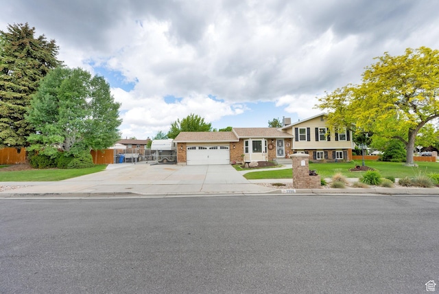 2298 W Jordan Meadows Cv, West Jordan, UT 84084 - split level home with a garage, concrete driveway, and brick siding