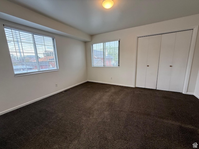 136 E 400 N Unit 108, Provo, UT 84606 - unfurnished bedroom with dark colored carpet, baseboards, and a closet