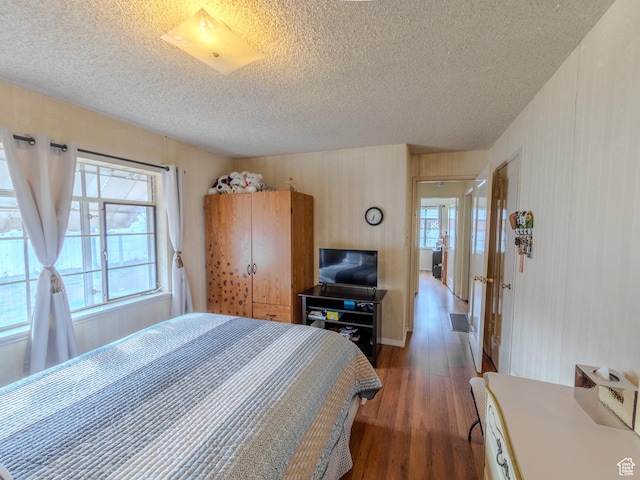 657 N Rambler Dr N, Salt Lake City, UT 84116 - bedroom featuring a textured ceiling, wood finished floors, and multiple windows