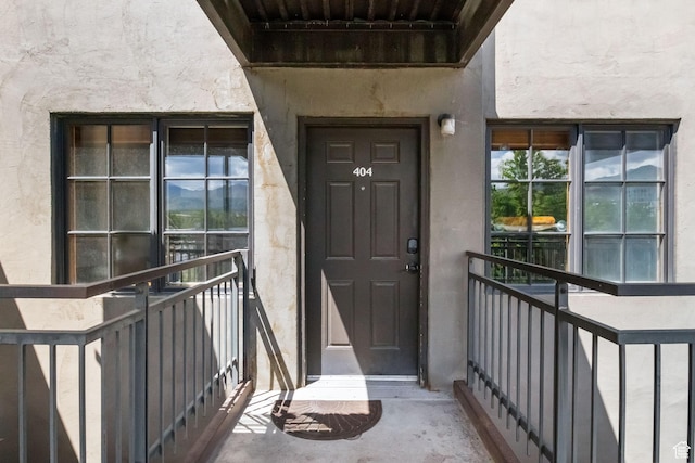 doorway to property featuring stucco siding