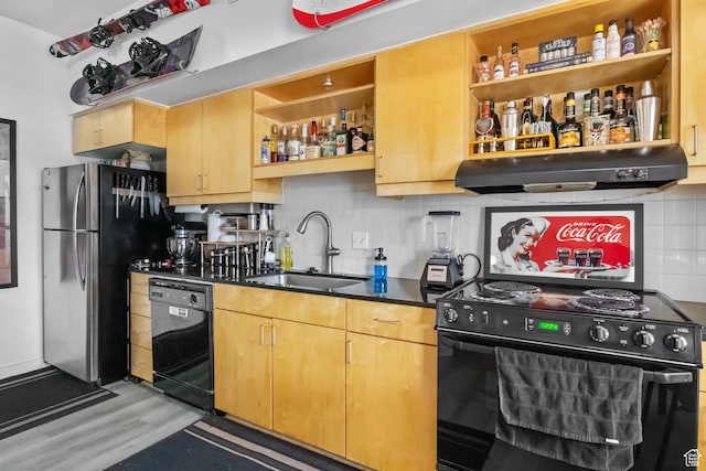 kitchen featuring black appliances, a sink, open shelves, under cabinet range hood, and light wood-style flooring