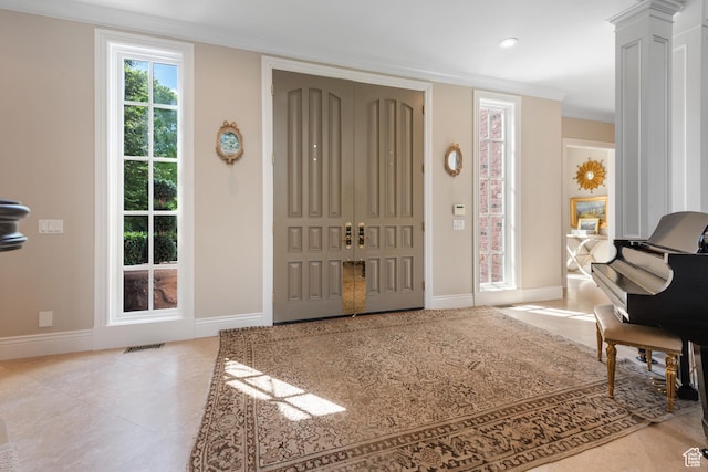entryway with baseboards, crown molding, tile patterned floors, and recessed lighting