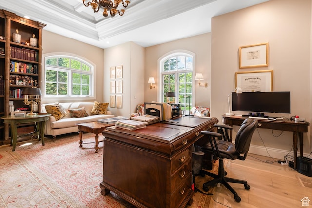 office with healthy amount of natural light, hardwood / wood-style floors, a chandelier, and ornamental molding