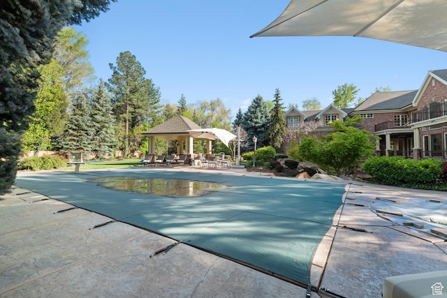 view of pool featuring a patio area and a covered pool