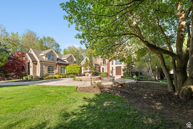 view of front facade with a front lawn and stone siding