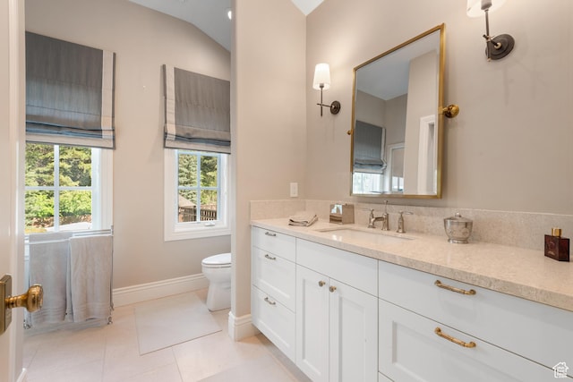 bathroom featuring vanity, baseboards, toilet, and tile patterned flooring