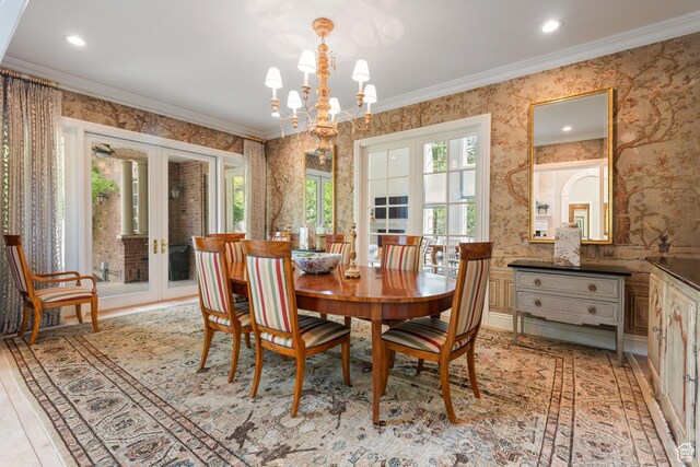 dining space with wallpapered walls, french doors, ornamental molding, a chandelier, and recessed lighting