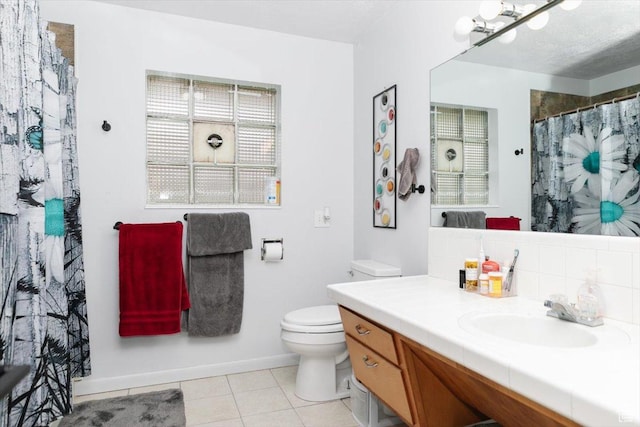 bathroom with toilet, tile patterned flooring, vanity, a shower with shower curtain, and baseboards
