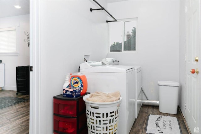 clothes washing area with independent washer and dryer and wood finished floors