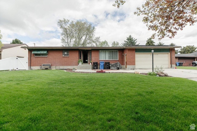 ranch-style home featuring brick siding, an attached garage, concrete driveway, and entry steps
