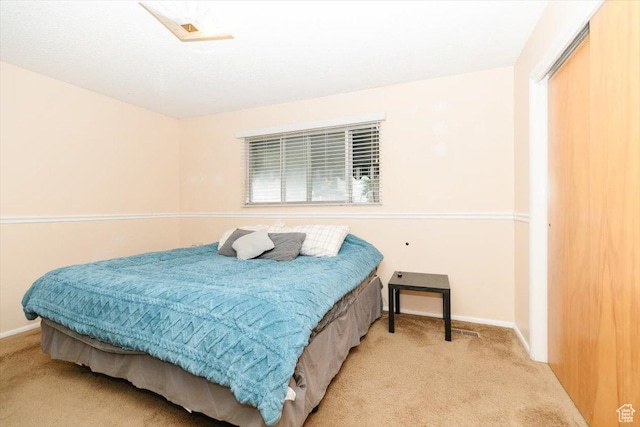 bedroom featuring carpet floors and baseboards