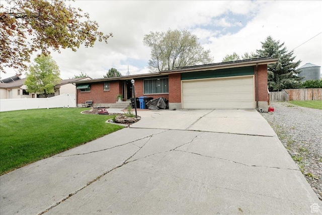 ranch-style house featuring concrete driveway, brick siding, and a garage