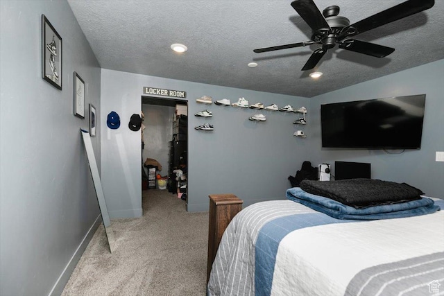 carpeted bedroom featuring baseboards, a textured ceiling, and ceiling fan