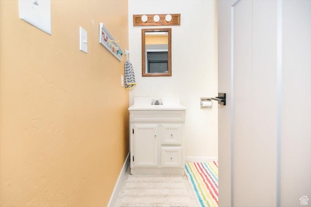 bathroom with baseboards and vanity