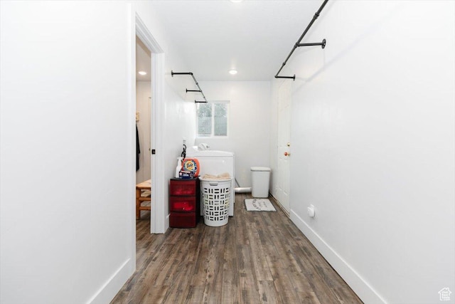 bathroom featuring wood finished floors, baseboards, and recessed lighting
