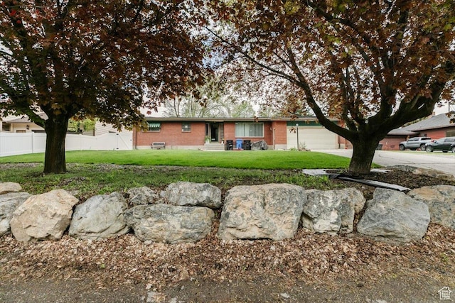 ranch-style home with an attached garage, driveway, and brick siding
