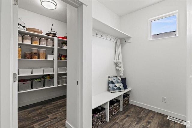 mudroom with wood finished floors and baseboards