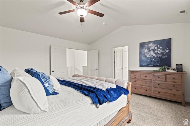 bedroom featuring lofted ceiling, light colored carpet, and a ceiling fan